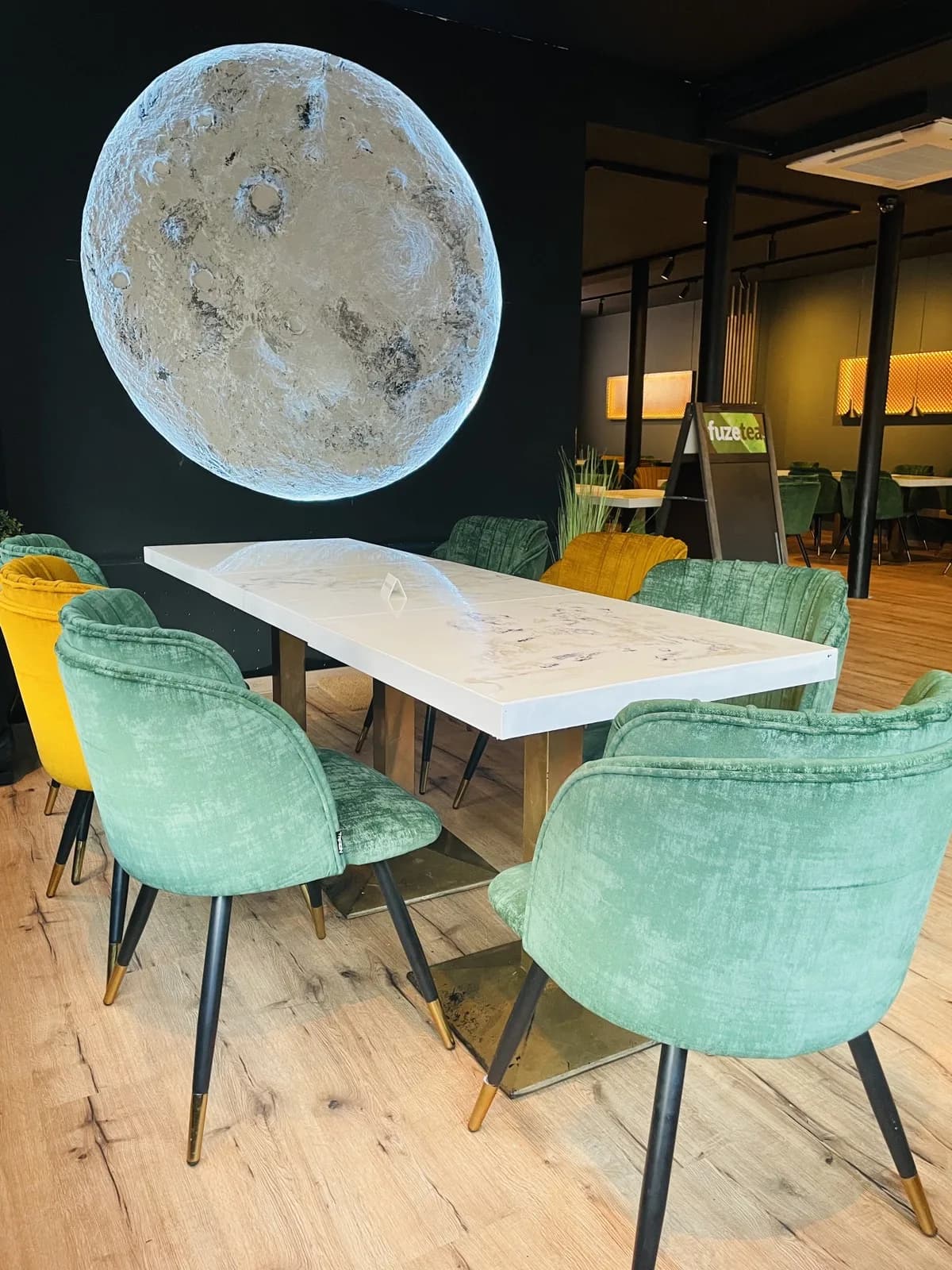 The moon-light installation and green velvet seating inside VegNation Utrecht